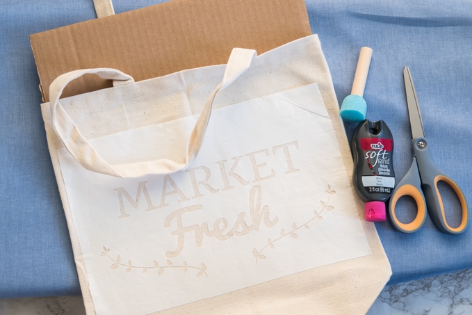 Learn how to DIY this cute farmer's market tote bag using the Cricut Explore. See how to use freezer paper to make a stencil in this full craft tutorial.